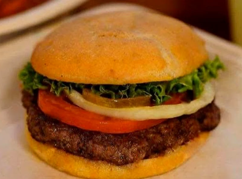 A Wells burger on a dedicated gluten-free bun with lettuce, tomato, onion and pickle