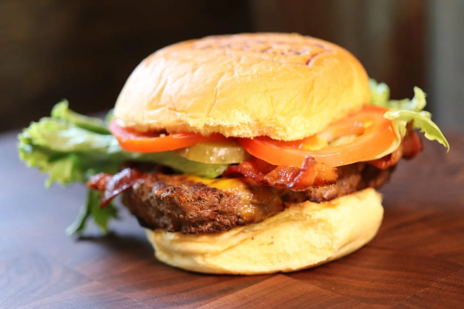 A Wells burger built on a gluten-free bun with bacon, cheese, lettuce and tomato