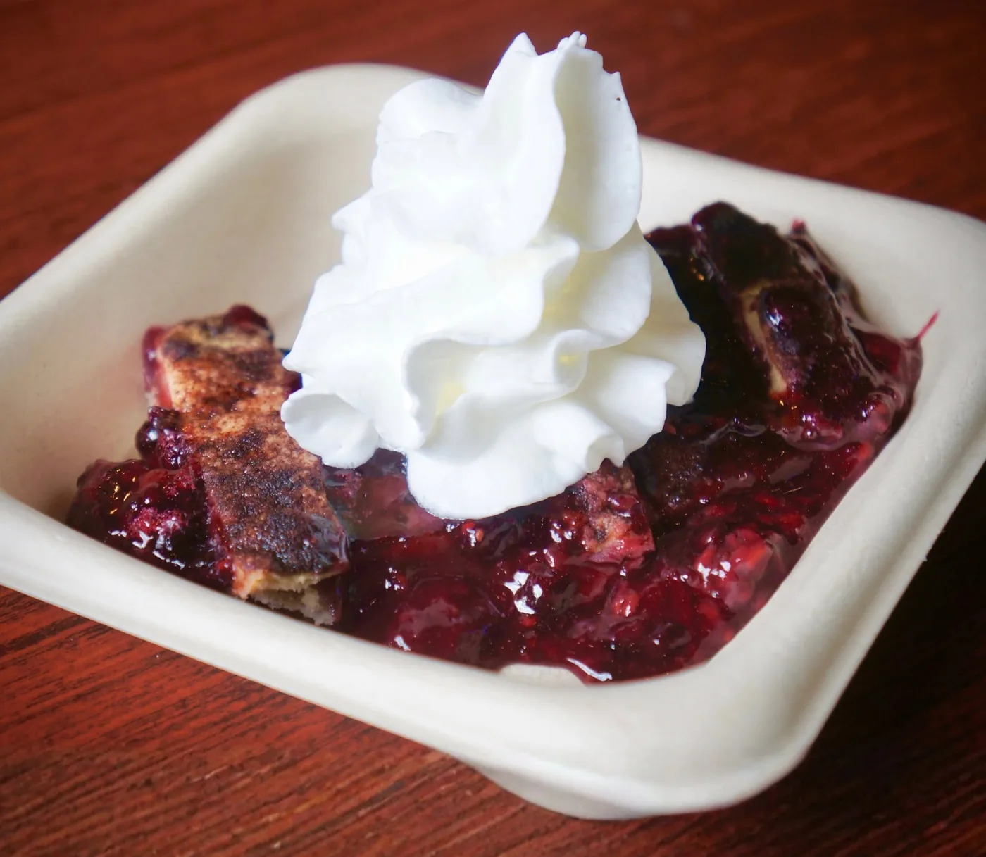 Keto four-berry cobbler under whipped cream