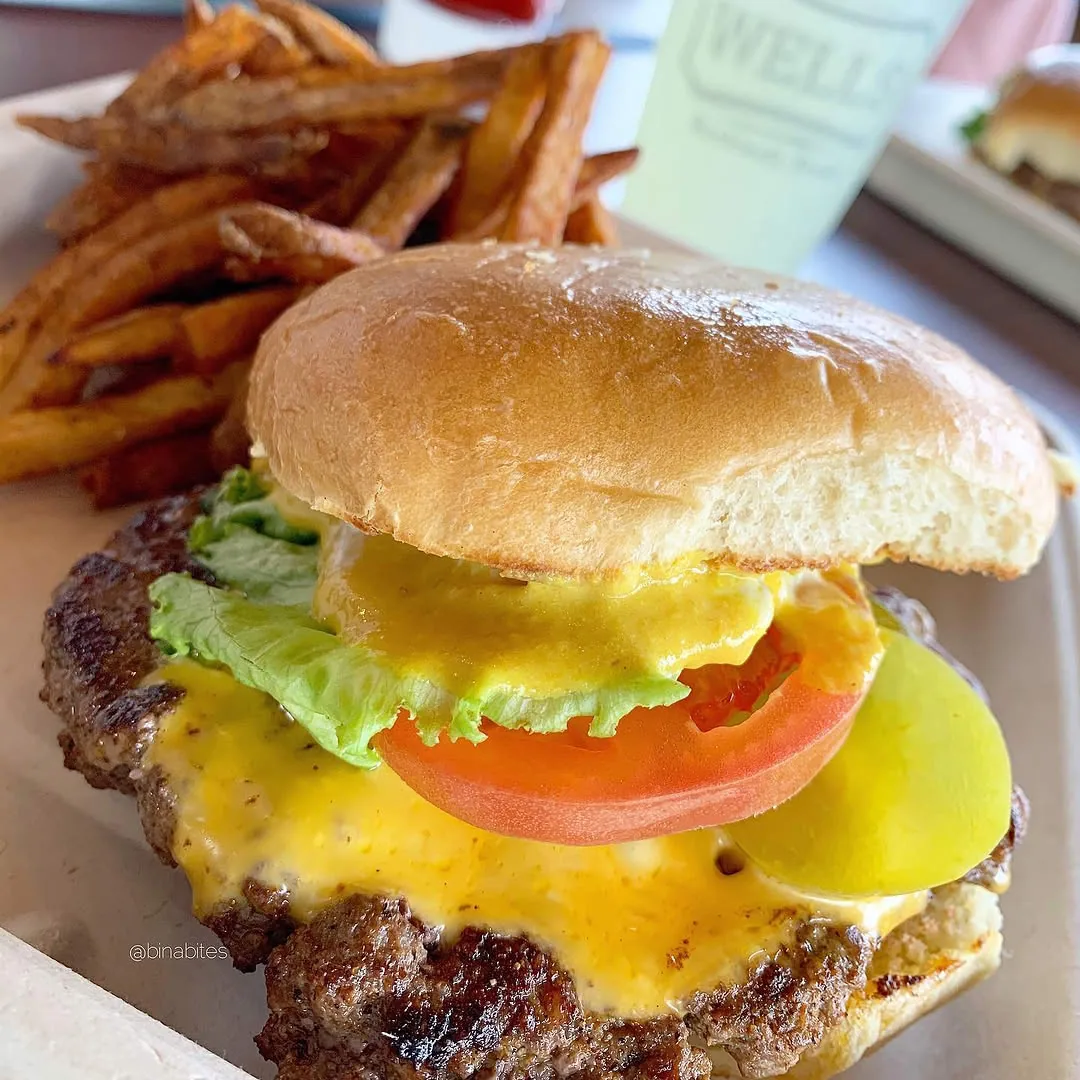 Cheeseburger on the 2-net-carb keto bun with lettuce, tomato and pickle, served with fries