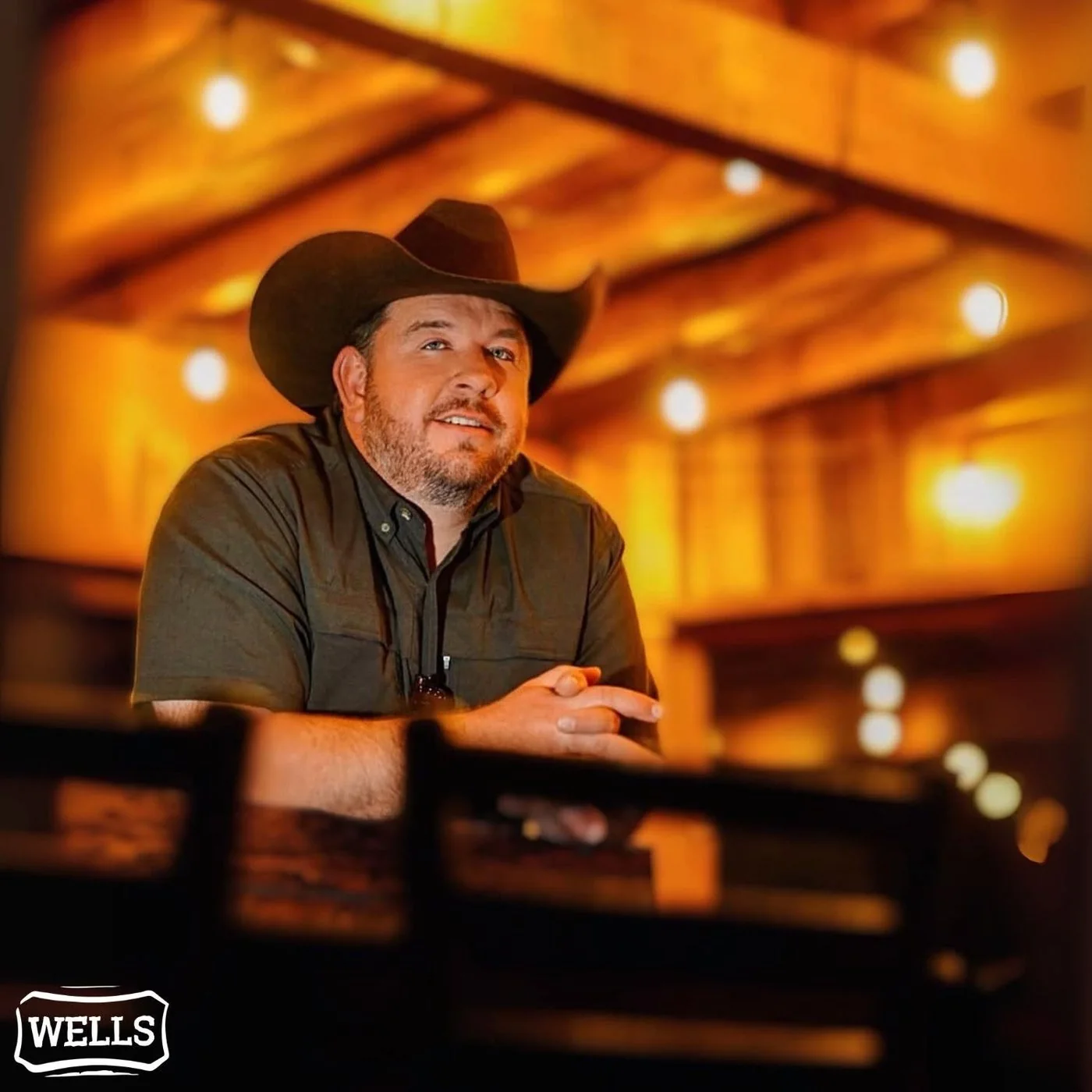Lee Wells under the string lights at Wells Cattle Co.